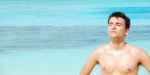 Man Standing Up Sunbathing In A Maldivian Island Stock Photo