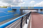 Bike Path And Car Road Under Blue Traffic Tunnel Stock Photo