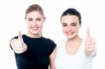 Two Girls Cheering Via With Thumbs Up Gesture Stock Photo