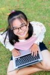 Lovely Girl With A Laptop On The Grass Stock Photo