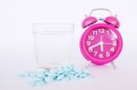 Alarm Clock ,pills And Glass Of Water Stock Photo