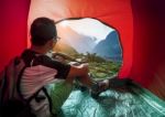 Camping Man In Camper Tent Looking To Beautiful Natural Water Falls Scenic Use For People Vacation Traveling To Destination Stock Photo