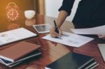 Woman Standing And  Writing Document Hand At Desk Stock Photo