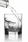 Water Pouring Into Glass With Its Reflection, Closeup View, Isol Stock Photo