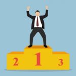 Businessman Celebrates On Winning Podium Stock Photo