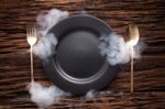 Black Empty Plate Fork Spoon On Wooden Table Background Stock Photo