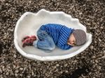 Kid In Eggshell Stock Photo