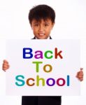 Schoolboy With Back To School Board Stock Photo