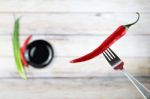 Red Hot Chili Pepper With Water Drops On Fork Stock Photo