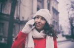 Woman In Red Coat And Wool Cap And Gloves With Smartphone Stock Photo