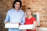 Happy Young Couple Holding Pizza Boxes Stock Photo