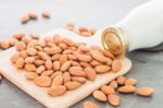 Almond Nuts On Wooden Plate With Milk Stock Photo