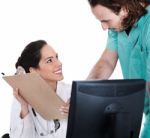 Doctor Explains Patient Record To The Male Nurse Stock Photo