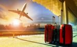 Stack Of Traveling Luggage In Airport Terminal And Passenger Plane Flying Over Building In City Stock Photo