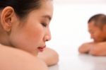 Young Asian Woman And Man Relaxing In Gym Stock Photo