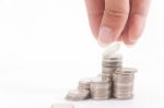 Stacking Coins By Hand Stock Photo