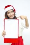 Smiley Asian Woman In Santa Hat Hold A Red Writeboard Stock Photo