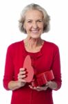 Senior Woman With Heart Shaped Gift Box Stock Photo