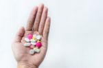 Top View Of The Pills On The Hand And White Background, A Hand Hold The Pills And Drug Stock Photo