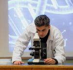 Scientist And Microscope Stock Photo