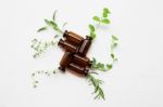 Top View, Bottle Of Essential Oil With Herbs Stock Photo