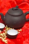 Jasmine Tea Over Red Silk Stock Photo