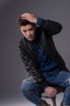 Casual Young Man In Black Leather Jacket And Denim Jeans Stock Photo