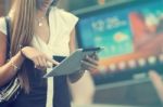 Young Woman With Tablet Computer Walking On Street Stock Photo