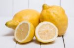 Yellow Lemons Over White Wood Background Stock Photo