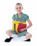 Sitting Schoolgirl Holding Books Stock Photo