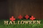 Wooden Halloween Words And Wooden Cross On Grass Background Stock Photo