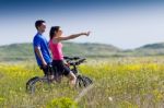 Happy Young  Couple On A Bike Ride In The Countryside Stock Photo