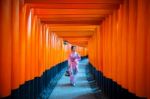 Asian Women In Traditional Japanese Kimonos At Fushimi Inari Shrine In Kyoto, Japan Stock Photo