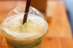 Iced Green Tea Latte With Milk Foam Stock Photo