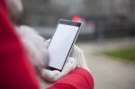 Mobile Phone In Hands With Glowes, Cold Weather Stock Photo