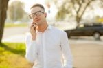 Man With Glasses Speak On Mobile Phone In Hands Stock Photo