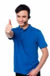 Young Man With Earphones And Thumb Up Stock Photo