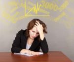 Tired Business Woman Sitting At The Table Stock Photo