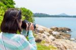 Young Woman Photography Near The Sea Stock Photo