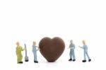 Miniature Worker Making Heart Shaped Chocolate On White Background , Stock Photo