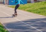 Young Woman Skateboarding In The Park Stock Photo