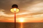 Lighting Of Warm Lamp And Lighting Of Sunset At Sea Stock Photo