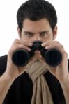 Young Man Holding Binocular Stock Photo