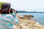 Young Woman Photography Near The Sea Stock Photo