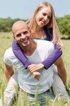 Two Young Lovers Holding Each Other Piggyback Stock Photo