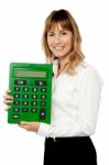 Smiling Lady Showing Big Green Calculator Stock Photo