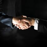 Handshaking business people Stock Photo