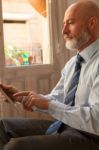 Businessman Middle-aged Working From Home With A Tablet Stock Photo