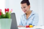 Woman With Laptop Working At Home Stock Photo