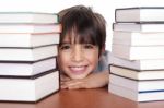 Happy Young School Boy Surrounded By Books Stock Photo